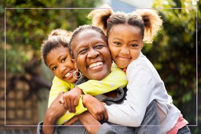 Grandmother hugging two granddaughters