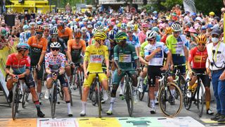 The leading riders line up at the start line of a Tour de France stage