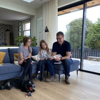 family on sofa with dog