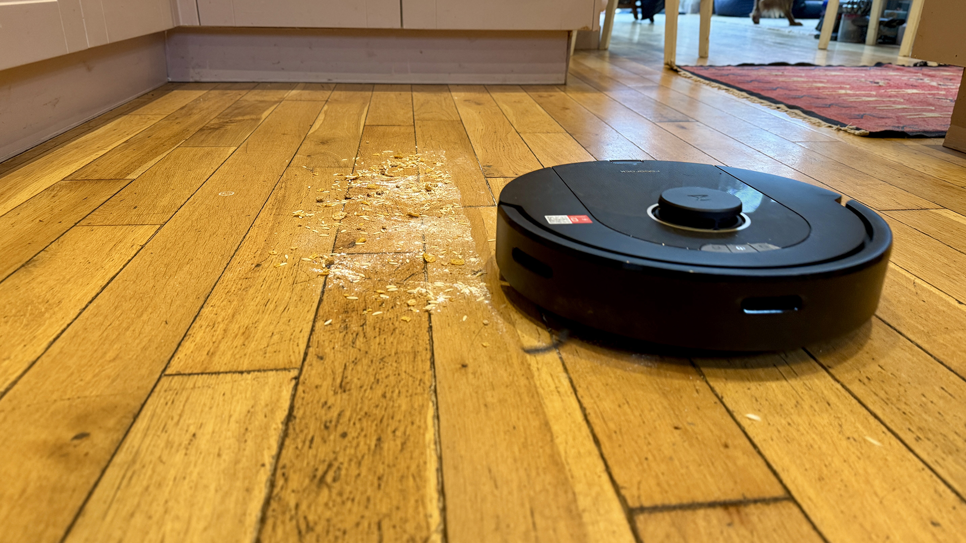 Roborock Q5 Pro Plus clearing flour and crumbs from a wooden floor