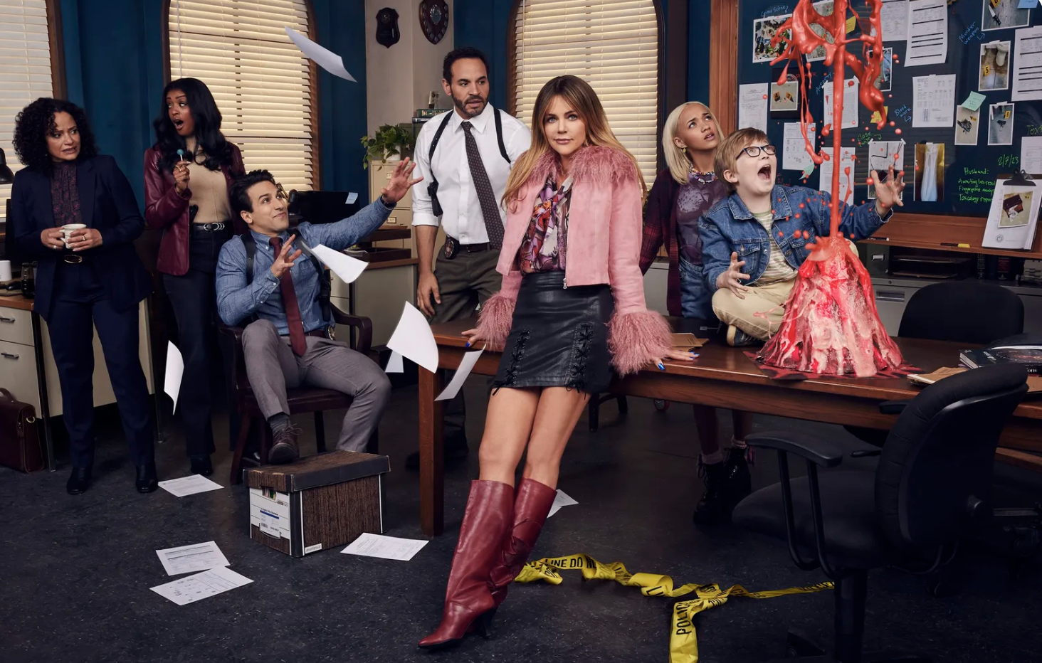 a promotional image from High Potential which shows the full main cast staged in a photo inside the police department