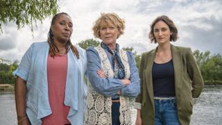 Jo Martin as Suzie, Samantha Bond as Judith and Cara Horgan as Becks stand in front of the river Thames in The Marlow Murder Club