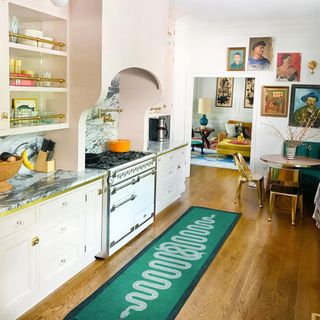An emerald green kitchen rug features two serpents
