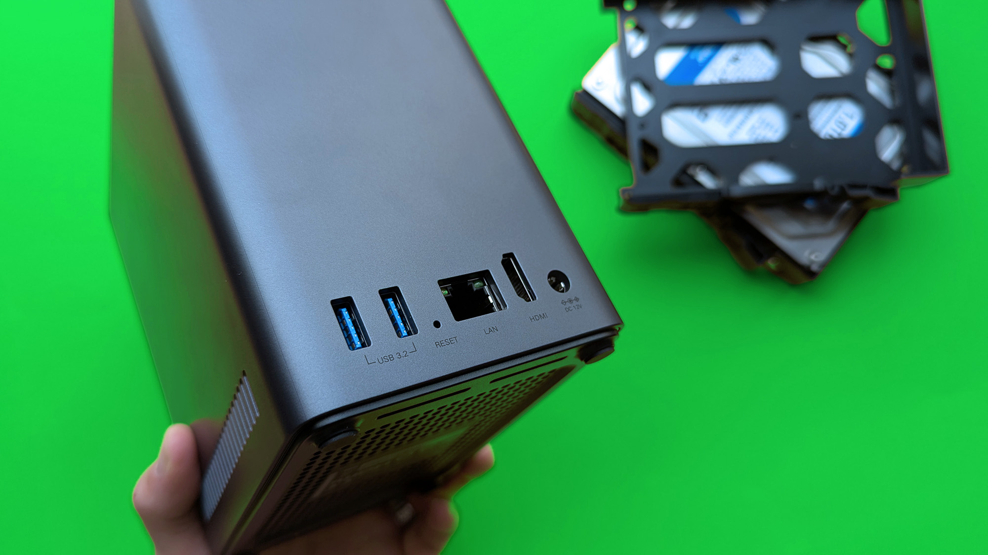 UGREEN NASync DH2300 on a green card paper background