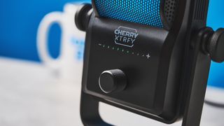 a small retro-inspired microphone with a large RGB sound capsule is photographed against a blue background