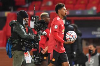 Marcus Rashford holds the match ball after his hat-trick for Manchester United against RB Leipzig in October 2020.