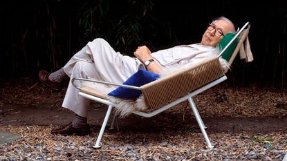 Hans J Wegner reclining on his Flag Halyard chair