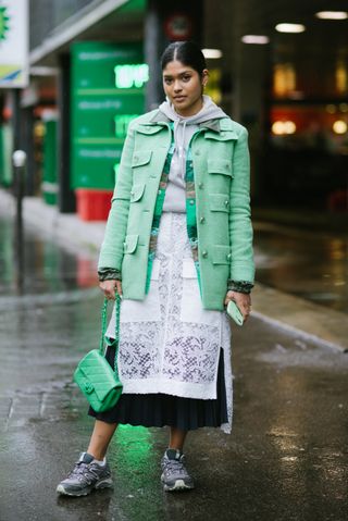 PARIS, FRANCE - MARCH 02: A guest poses wearing Sacai, a Chanel bag and Salomon trail shoes after the Sacai show during Paris Fashion Week Womenswear Fall/Winter 2020/2021 on March 02, 2020 in Paris, France. (Photo by Vanni Bassetti/Getty Images)