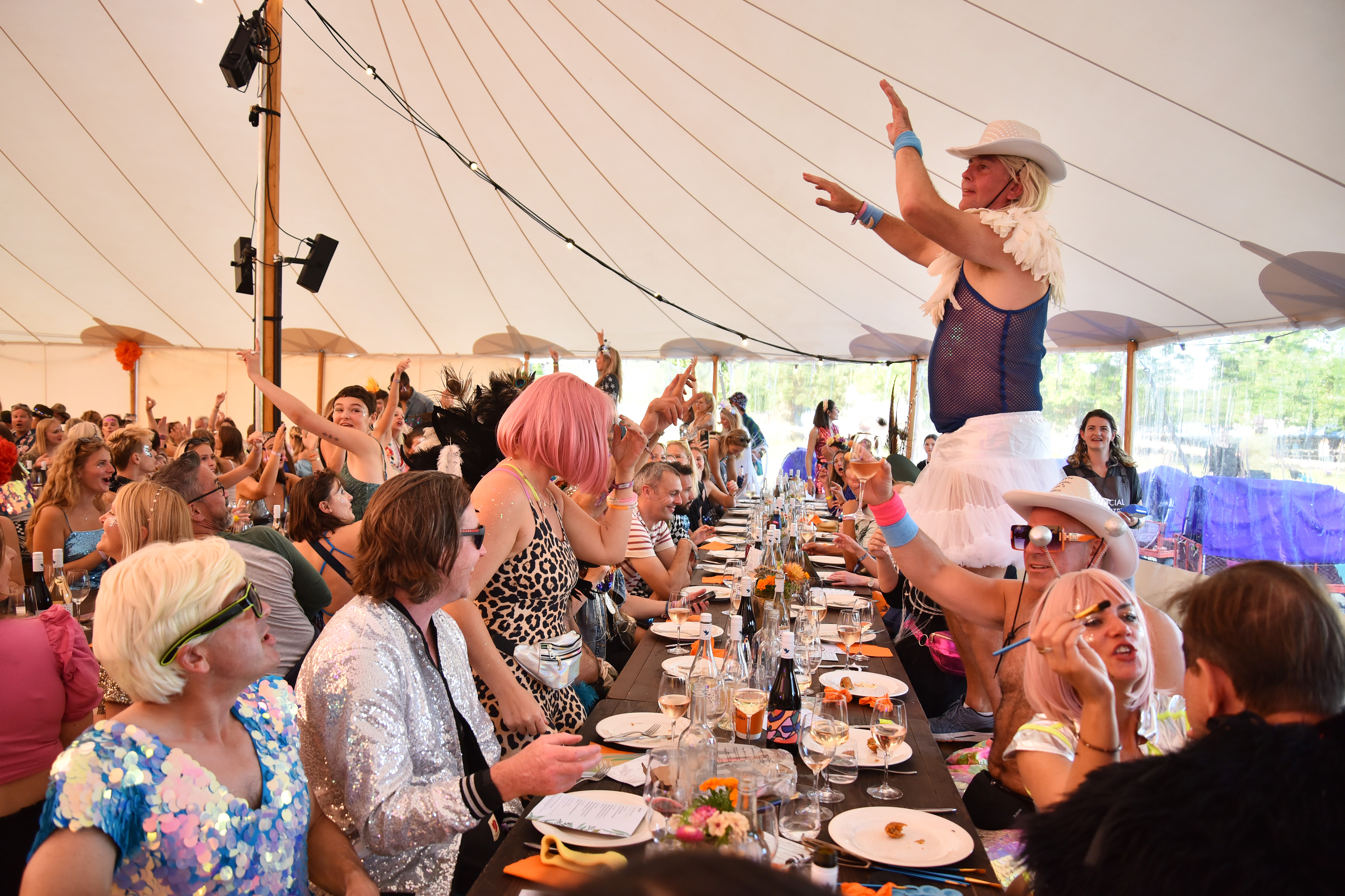 Festival goers enjoy the atmosphere as chef Angela Hartnett hosts a long table banquet during Wilderness Festival at Cornbury Park on August 02, 2025 in Charlbury, Oxfordshire.
