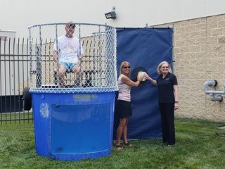 Almo's Warren Chaiken in the dunk tank with help from Maureen Mead, also of Almo, and Nancy Onffroy, Samsung.