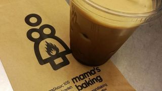 Mama's Baking logo on a napkin with coffee in a plastic cup
