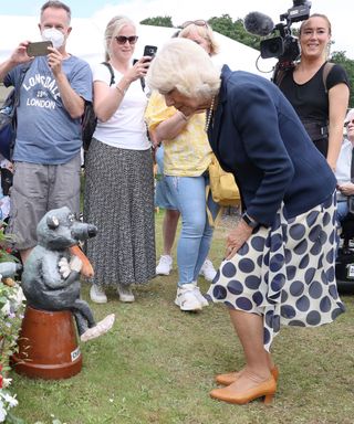 Camilla Queen Consort looking at a garden gnome called Charles