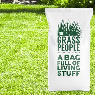 The Grass People bag of grass seed on a perfect grass lawn
