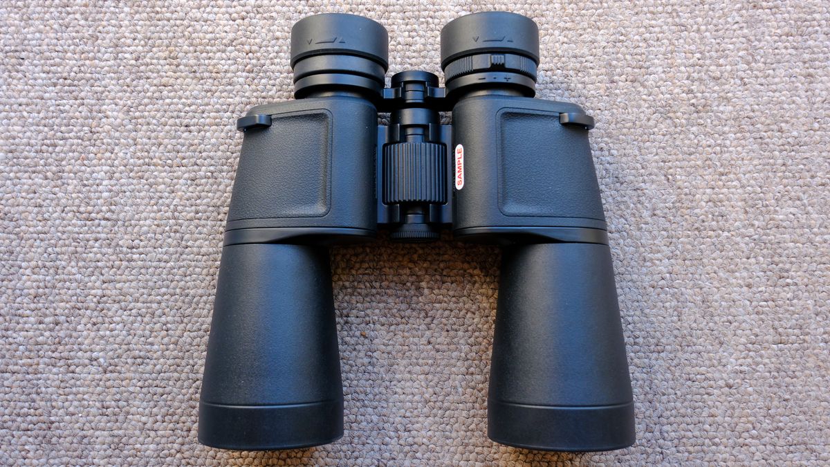 The Nikon Action 7x50 binoculars on a brown carpet, showing chassis, fousing dial and eyecups.