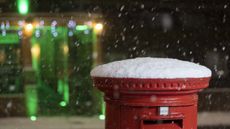 A view of a snow covered mailbox during snowfall in London on 11 December
