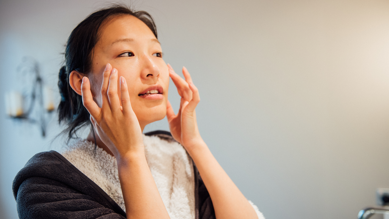 Woman applying a cleanser