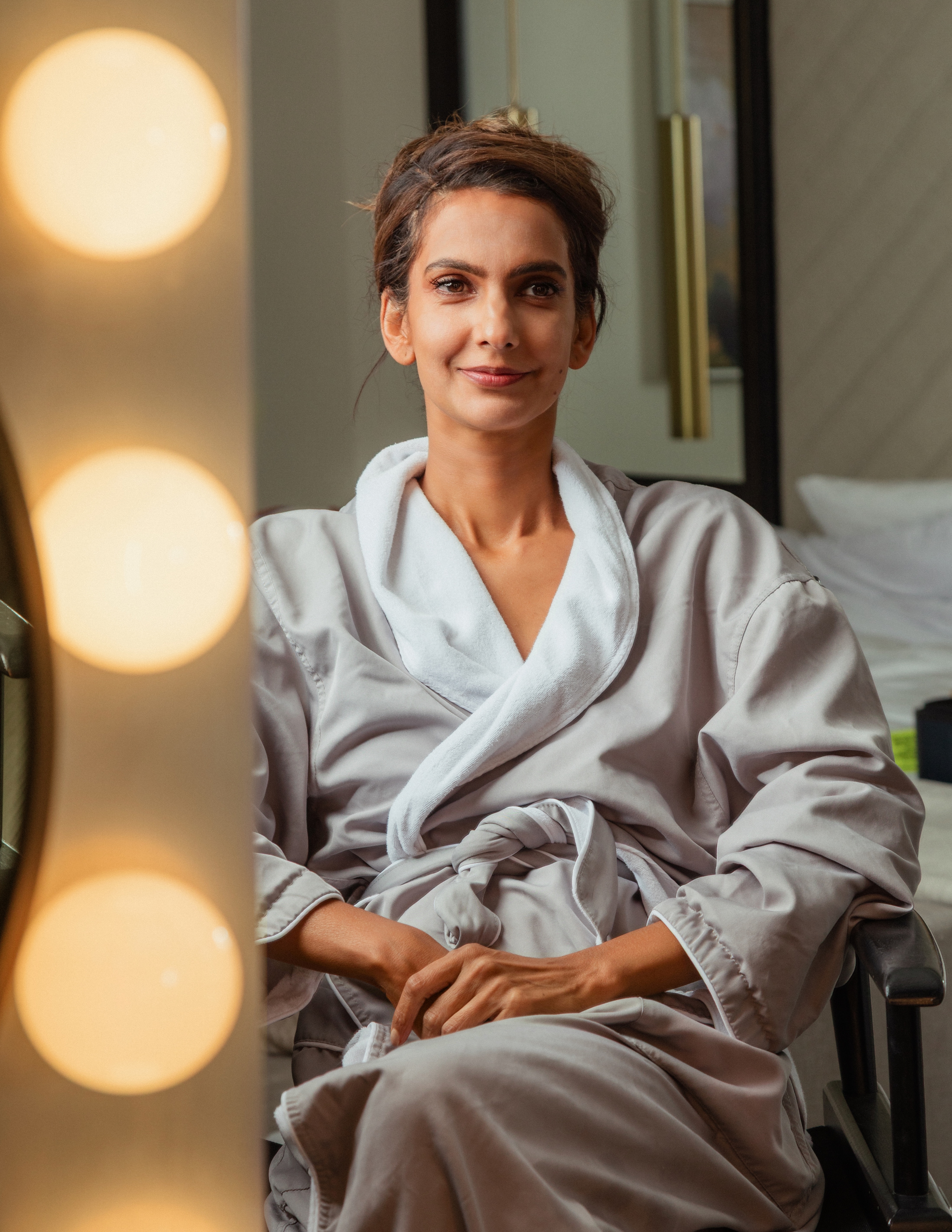 Poorna Jagannathan getting ready for the premiere of 'Lanterns' in L.A., wearing a black-and-green cool from Mugler.