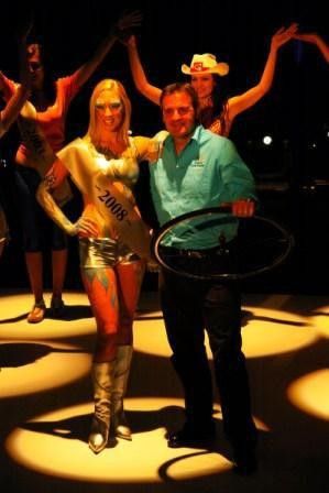 Race director Mike Turtur poses for photos with one of the podium girls.