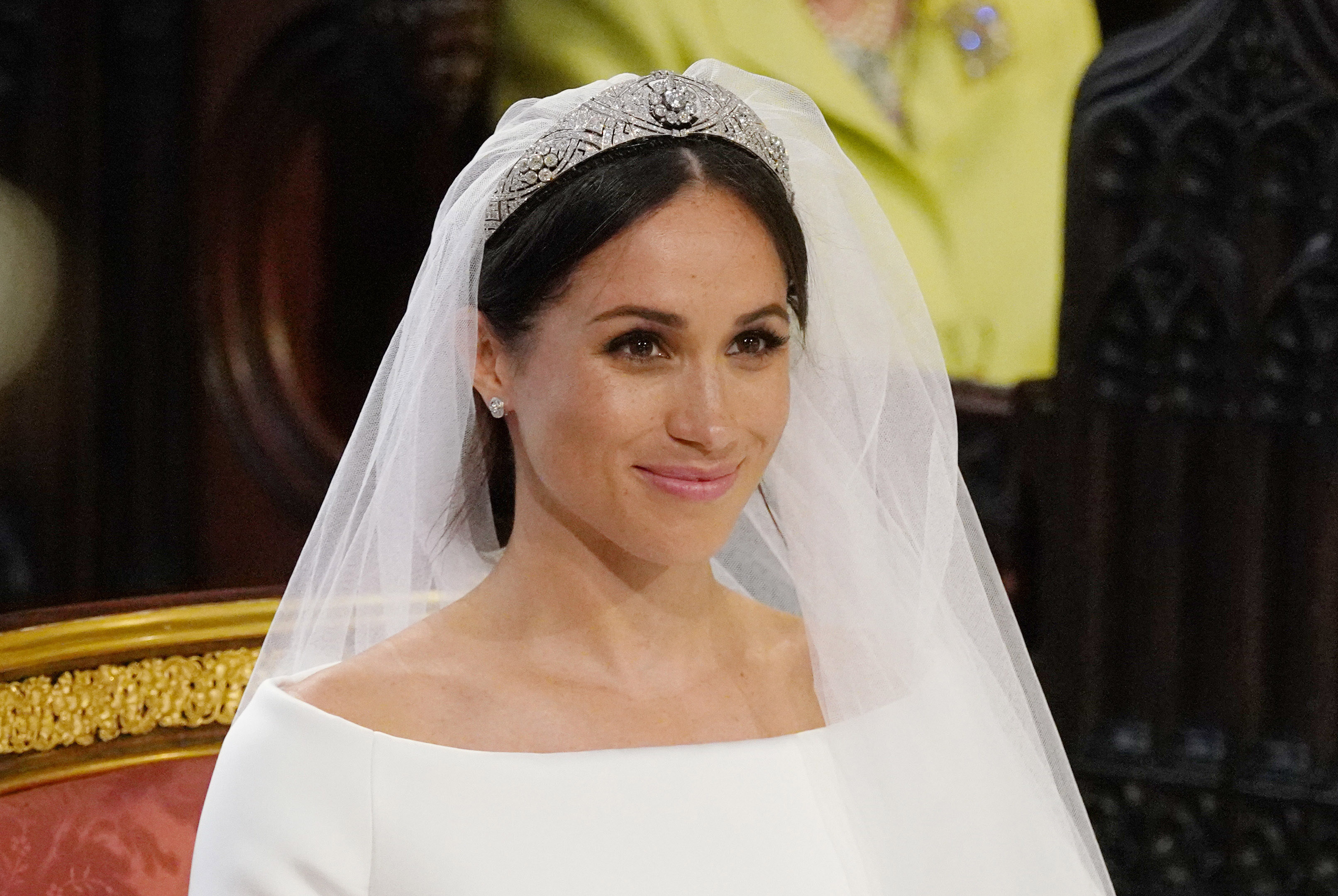 Meghan Markle smiling in a veil and tiara on her wedding day