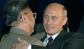 Russian President Vladimir Putin (R) hugs North Korean leader Kim Jong Il (L) during their meeting in the far eastern city of Vladivostok, 23 August 2002. Talks are expected to focus on bilat