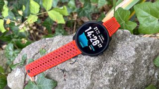Suunto Race 2 with orange strap on a rock outside