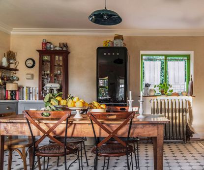 A French country style kitchen with a smeg fridge and a wooden kitchen table