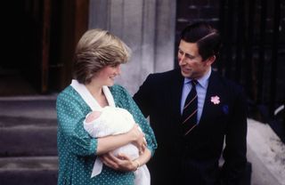 Princess Diana holding a newborn Prince William with Prince Charles outside hospital
