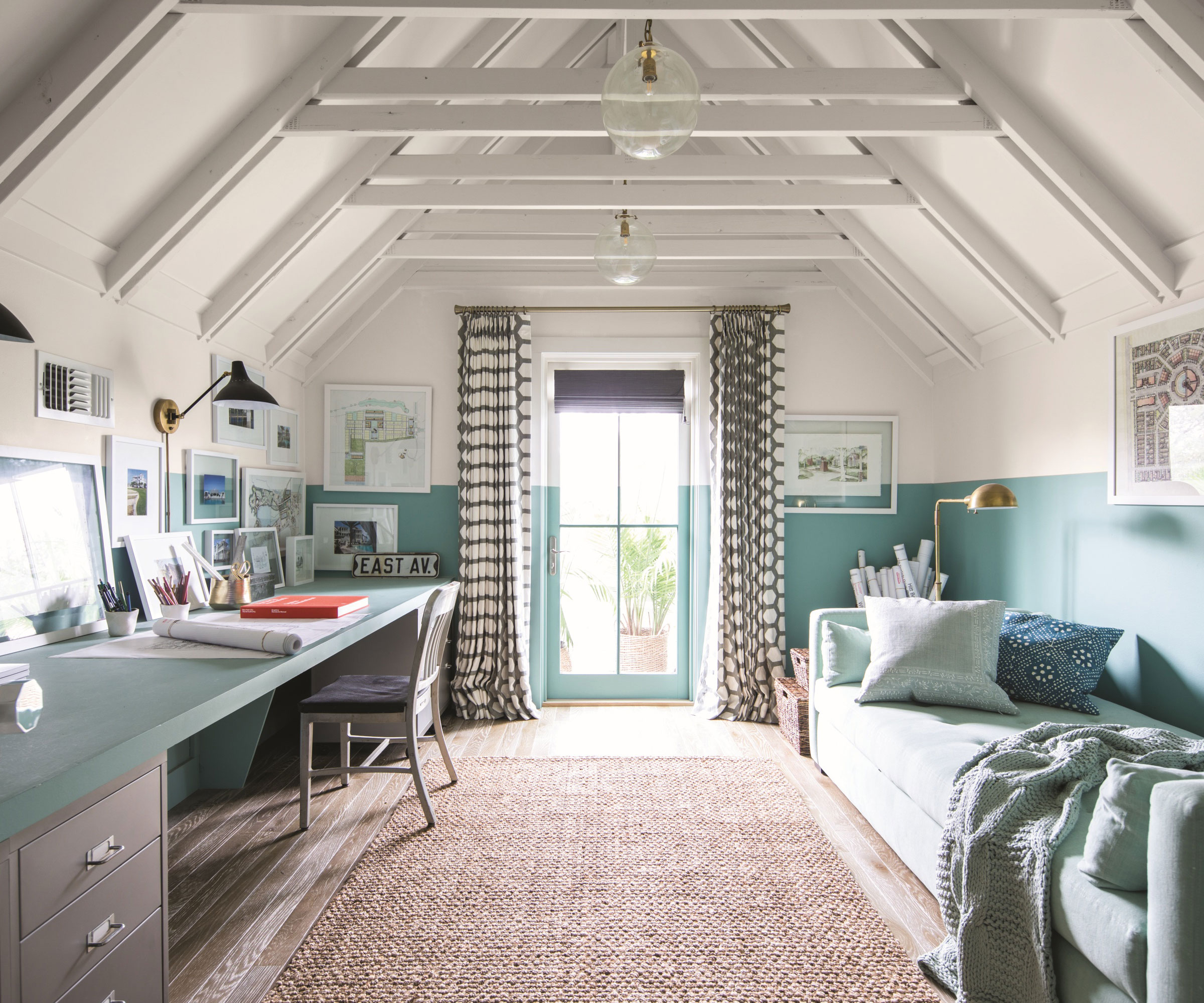 white and pale blue bedroom loft conversion with long desk