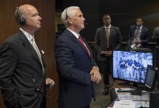 Vice President Mike Pence (right) and Rep. Robert Aderholt, R-Alabama speak with NASA astronauts Joe Acaba, Randy Bresnik and Mark Vande Hei on the International Space Station from the Payload Operations Integration Center at NASA's Marshall Space Flight Center in Huntsville, Alabama on Sept. 25, 2017.