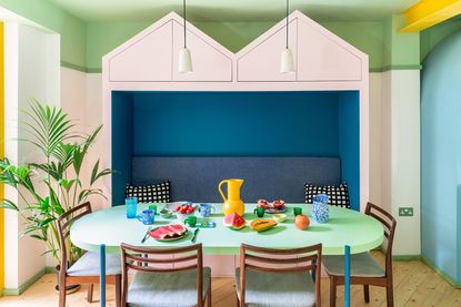 dining space decorated in digital colors of green, blue, pink and yellow