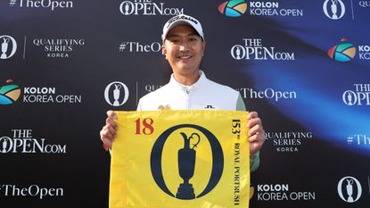 Sadom Kaewkanjana holds up The Open Championship pin flag after winning the 2025 Korea Open and qualifying for Royal Portrush
