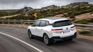 BMW iX in white on mountain roads
