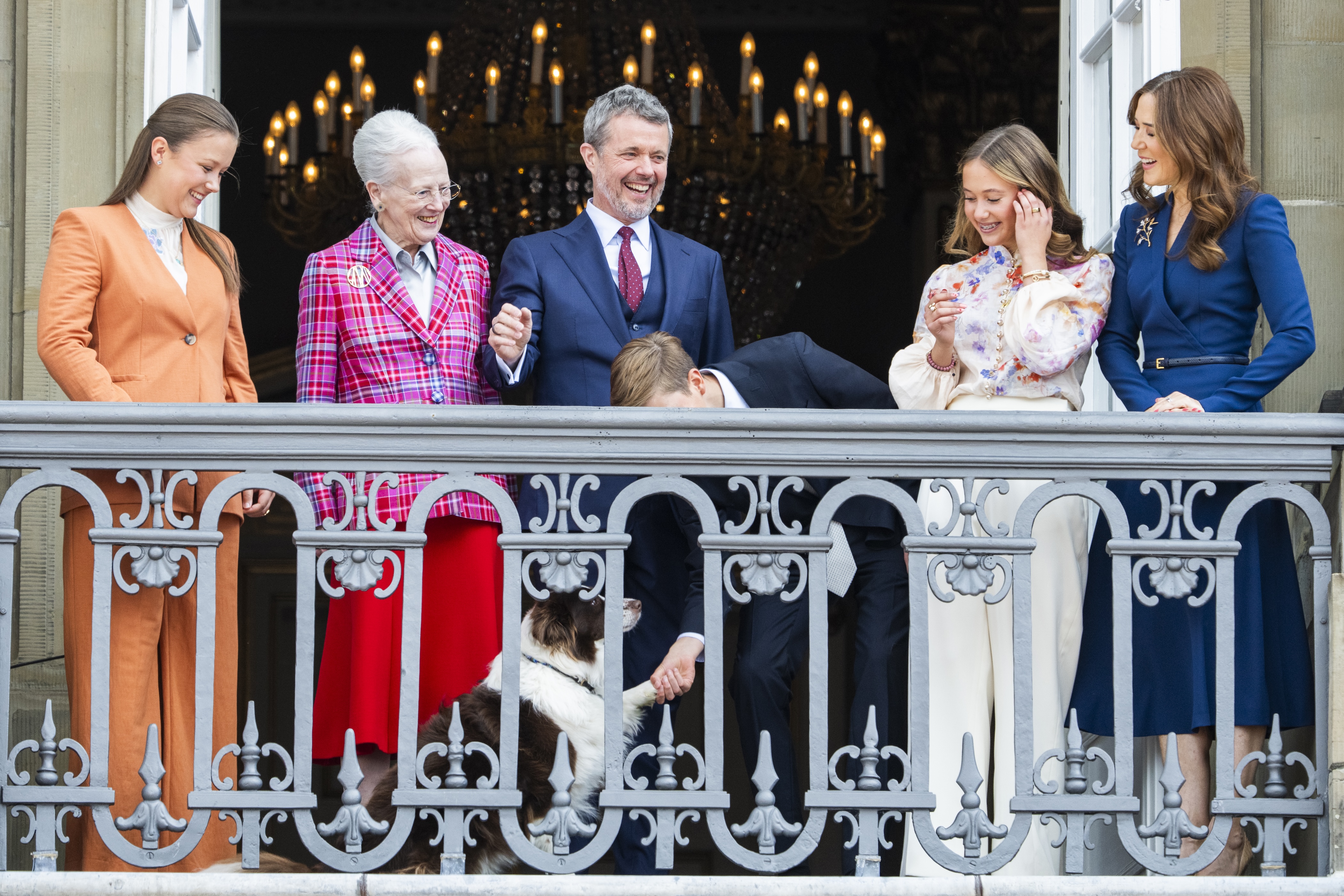 Princess Isabella of Denmark, Queen Margrethe of Denmark, King Frederik X of Denmark, Prince Vincent of Denmark, Princess Josephine of Denmark, Queen Mary of Denmark and their dog on the balcony