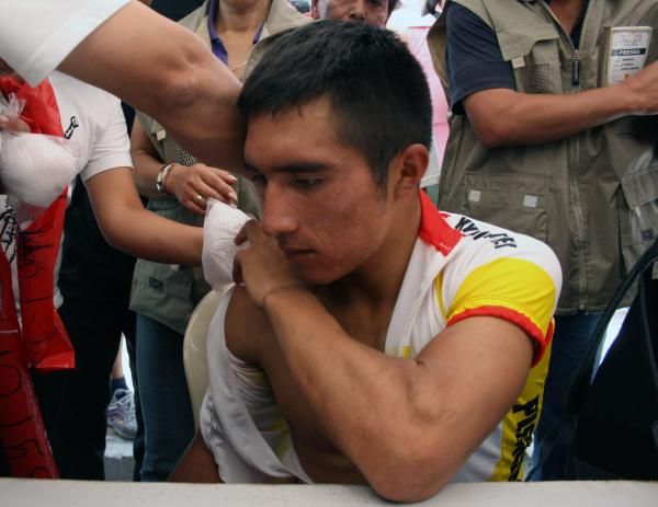 A rider gets medical attention after stage two.