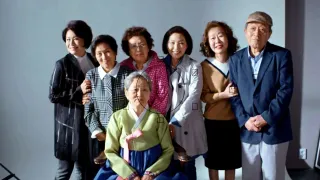 A group of seniors pose for a group photo in a photography studio, in 'Dear My Friends.'