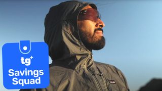 the patagonia houdini jacket being worn by a male hiker outside