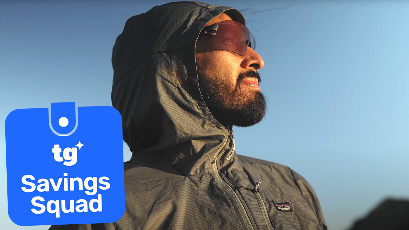 the patagonia houdini jacket being worn by a male hiker outside