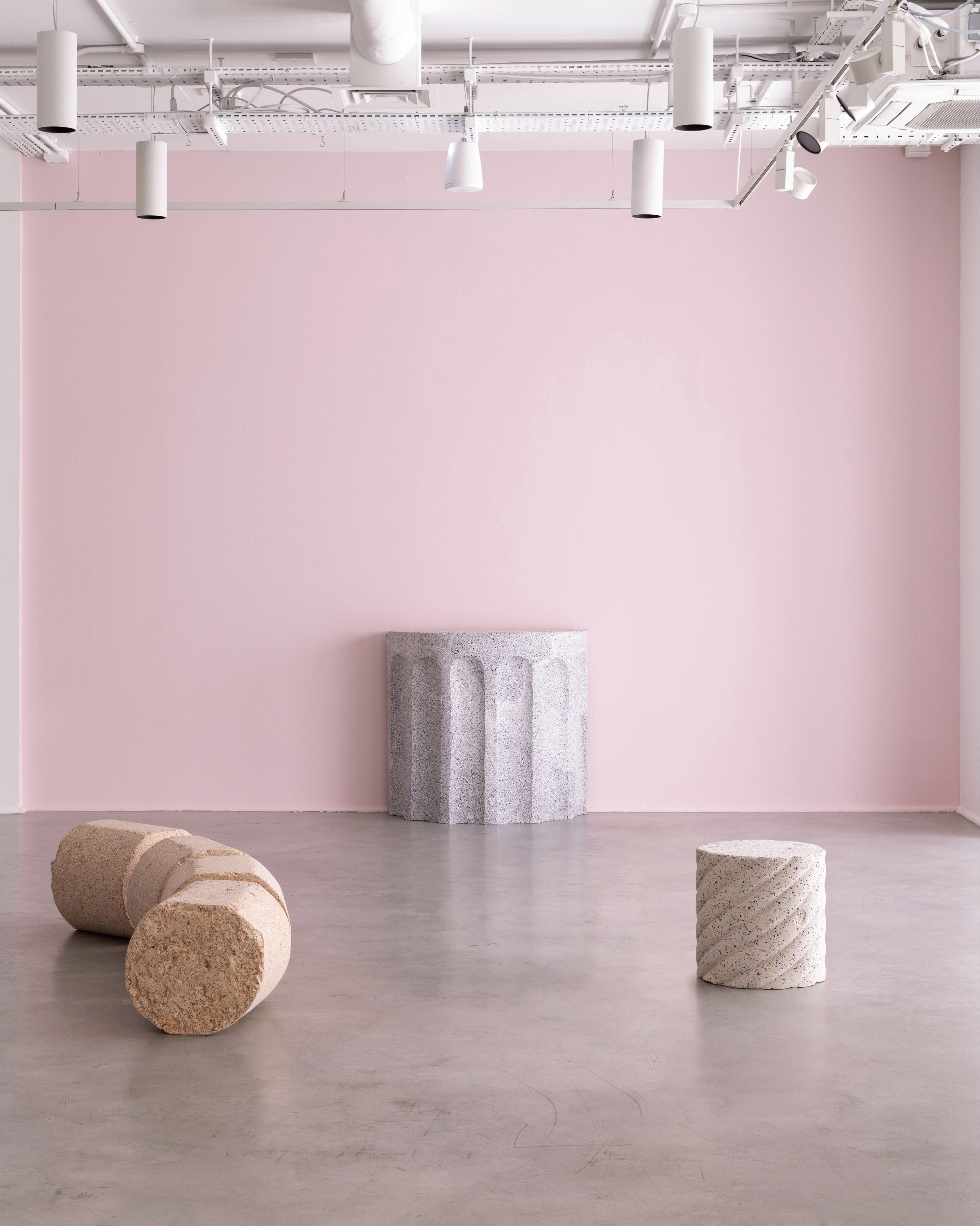 Rubber furniture installed in pink gallery space with concrete floor