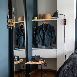 Navy wall with full-length mirror