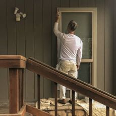 Man painting the outside of a house