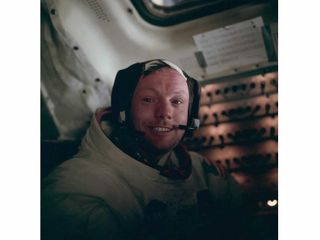 Neil Armstrong sits in the lunar module after a historic moonwalk.