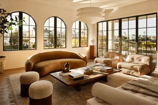 a bright living room with a croissant shaped sofa