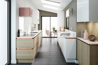 galley kitchen with white and grey scheme and light wood cabinets by wren kitchens