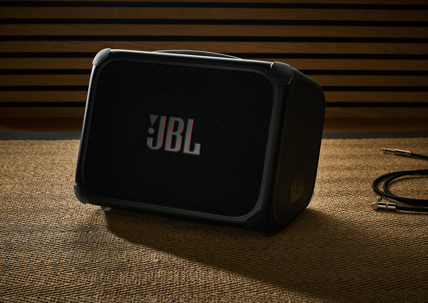 The JBL BandBox Trio PA speaker and guitar amp on a rug