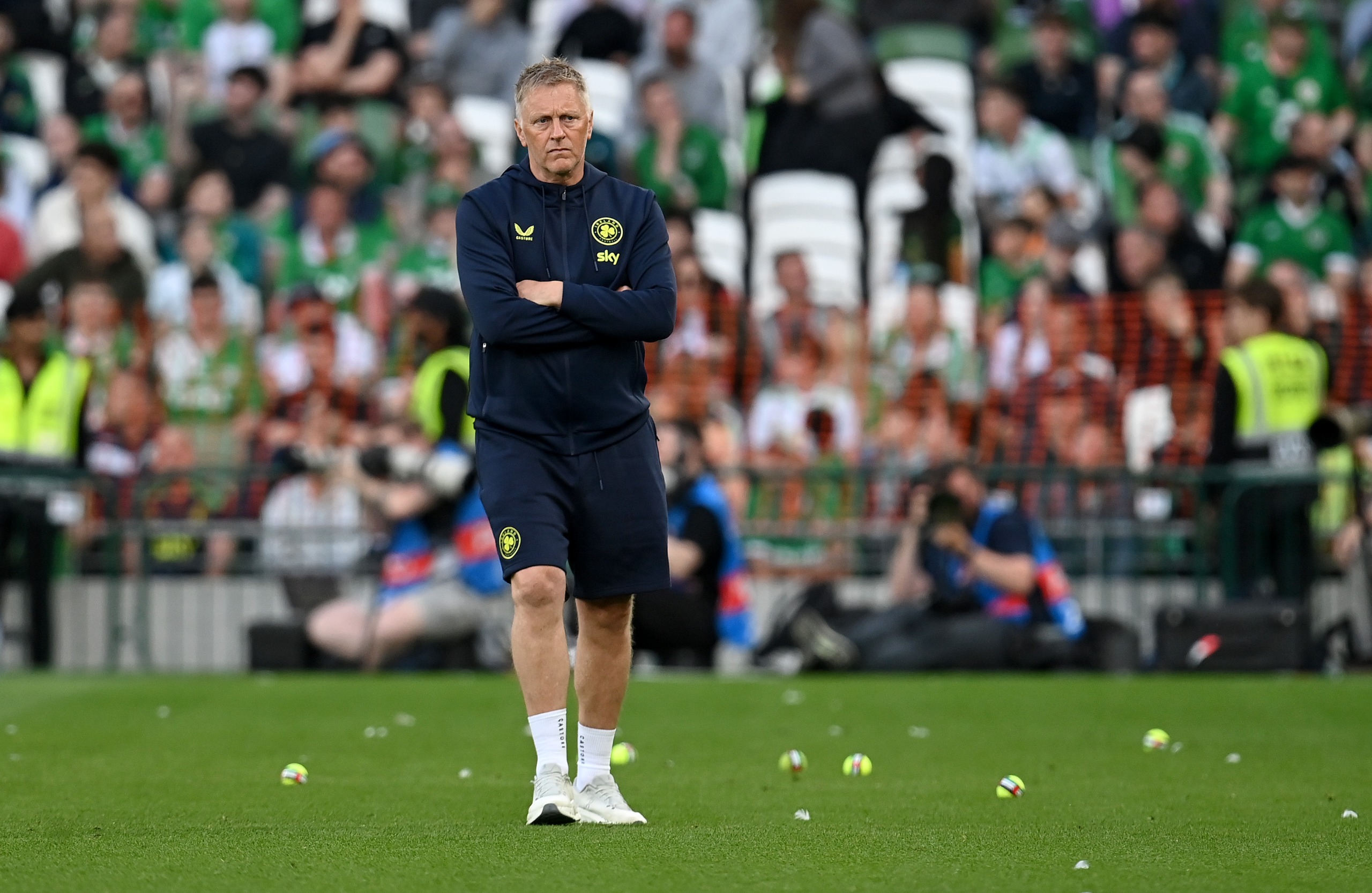 Heimir Hallgrimsson, Head Coach of Republic of Ireland, helps to clear tennis balls which have been thrown onto the pitch as a protest to an upcoming match between Republic of Ireland and Israel during the international friendly match between Republic of Ireland and Qatar at Aviva Stadium on May 28, 2026 in Dublin, Ireland