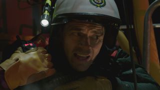 EMBARGOED 10 JUNE. Iain Dean in emergency equipment climbing up the confined space of a crane.