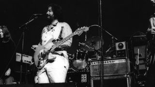 Lowell George performing onstage with the rock and roll band "Little Feat"