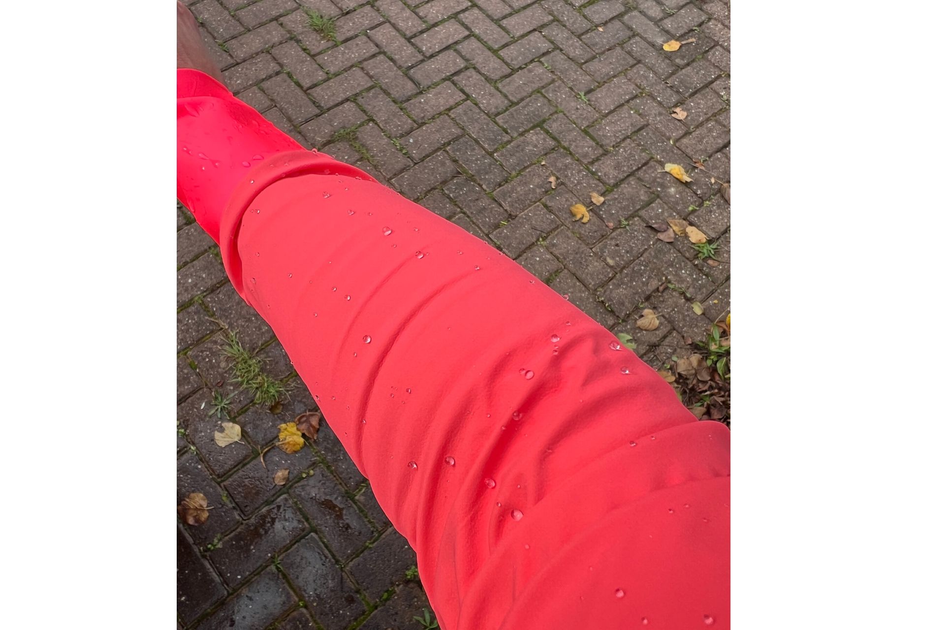 Water beading on the arm of the pink Santini Guard Neo rain jacket