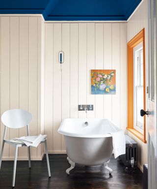 white painted bathroom with toungue and groove walls and blue painted ceiling