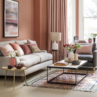 rose gold living room with sofa and carpet flooring